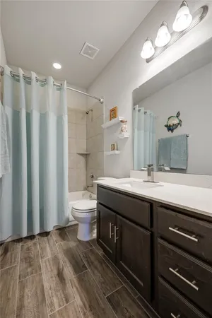 a bathroom with a double vanity sink toilet and shower