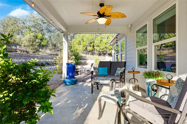 a view of a dining room with furniture water view and potted plants
