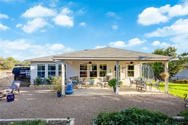 a view of a house with a backyard patio and a garden