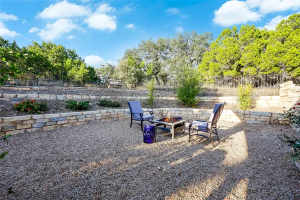 a view of backyard with outdoor seating and green space