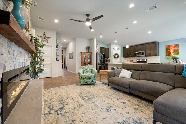 a living room with furniture and a fireplace