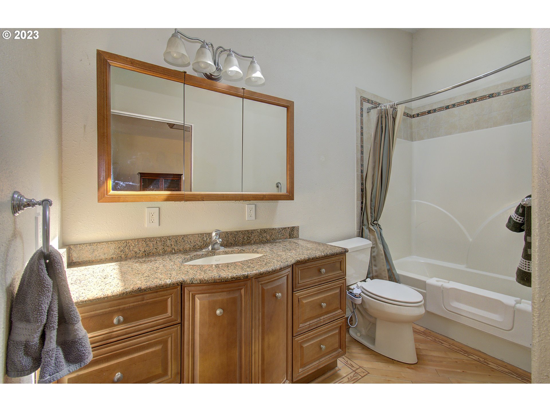 271 28th Avenue Longview, WA 98632 - Photo 16 of 29 a bathroom with a granite countertop sink toilet and shower