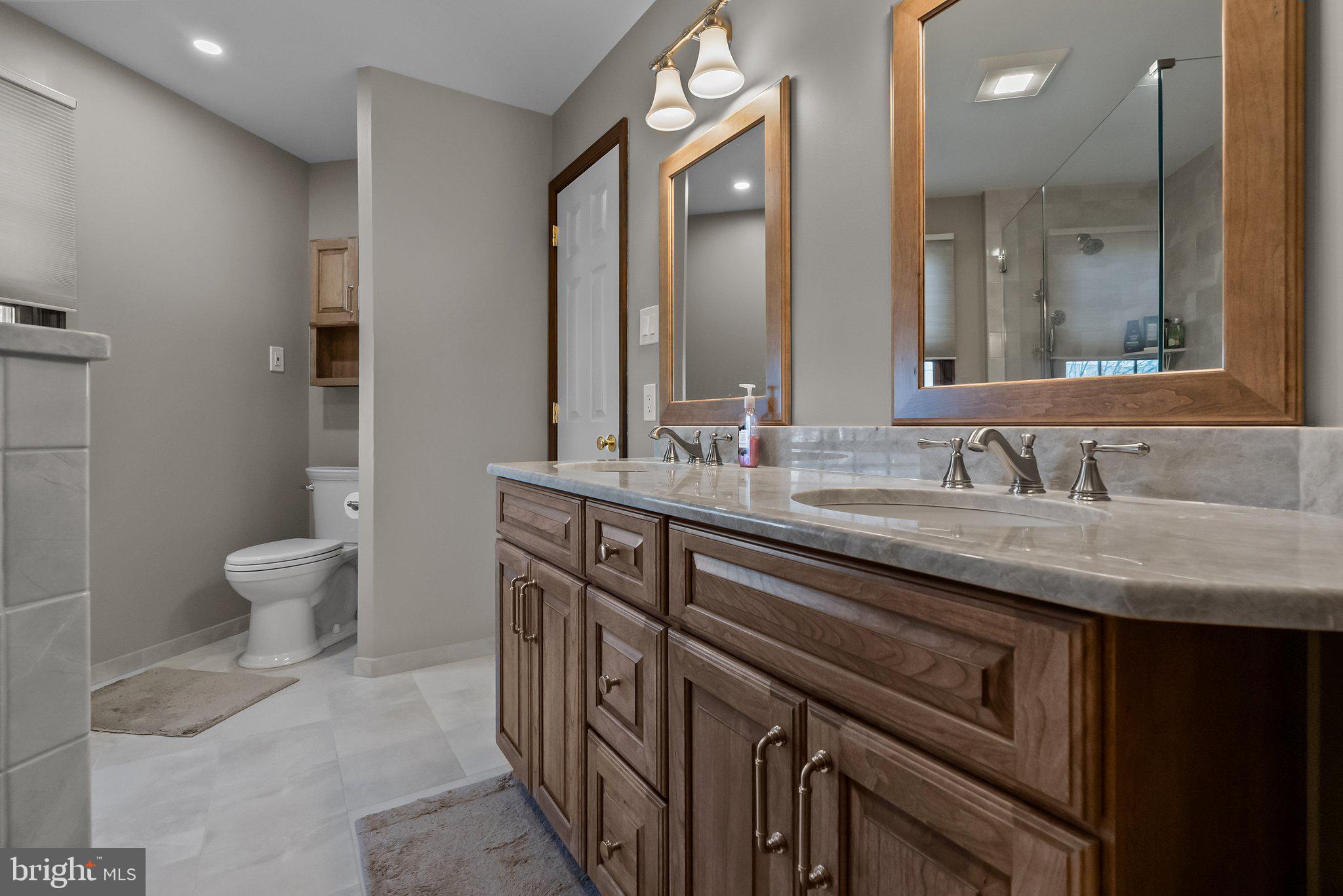 26 Hidden Turn Newtown, PA 18940 - Photo 22 of 40 a bathroom with a granite countertop sink a toilet and a mirror