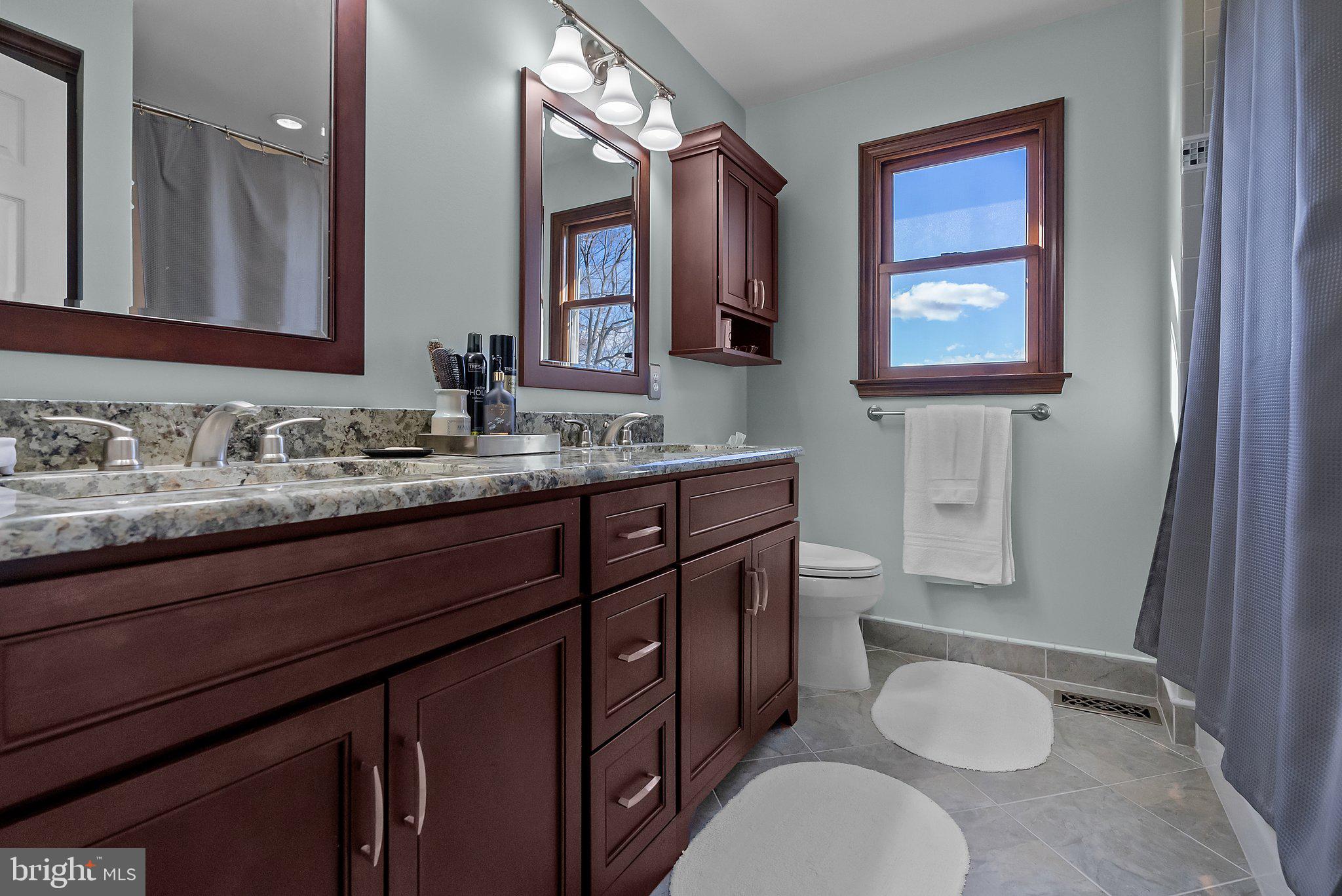 26 Hidden Turn Newtown, PA 18940 - Photo 27 of 40 a bathroom with a granite countertop toilet sink and mirror