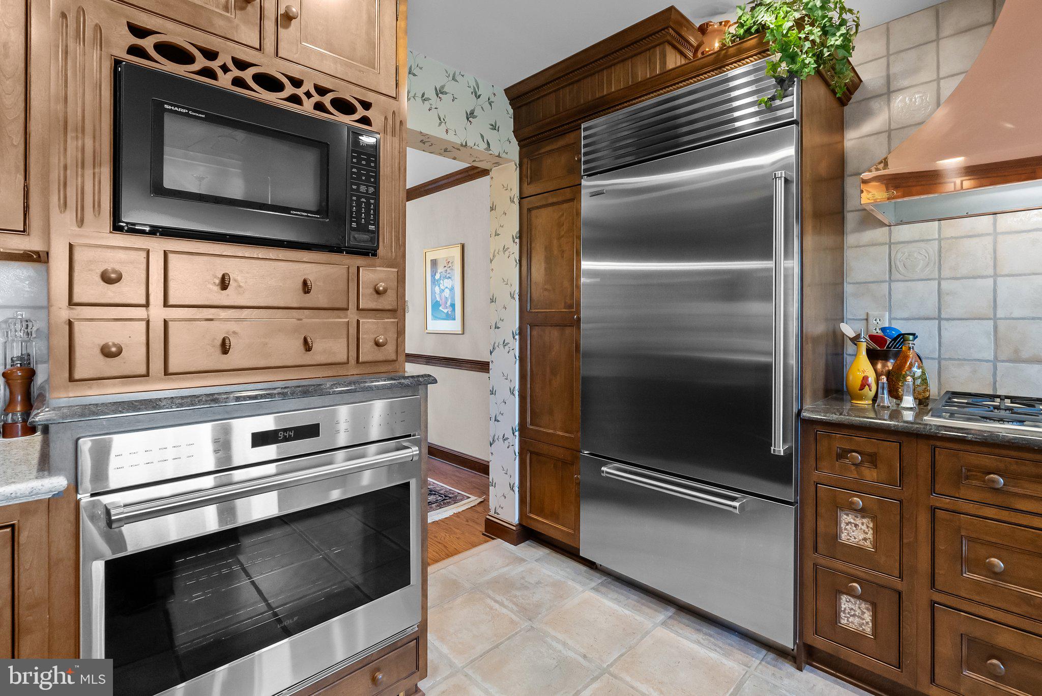 26 Hidden Turn Newtown, PA 18940 - Photo 7 of 40 a kitchen with granite countertop a stove and a microwave
