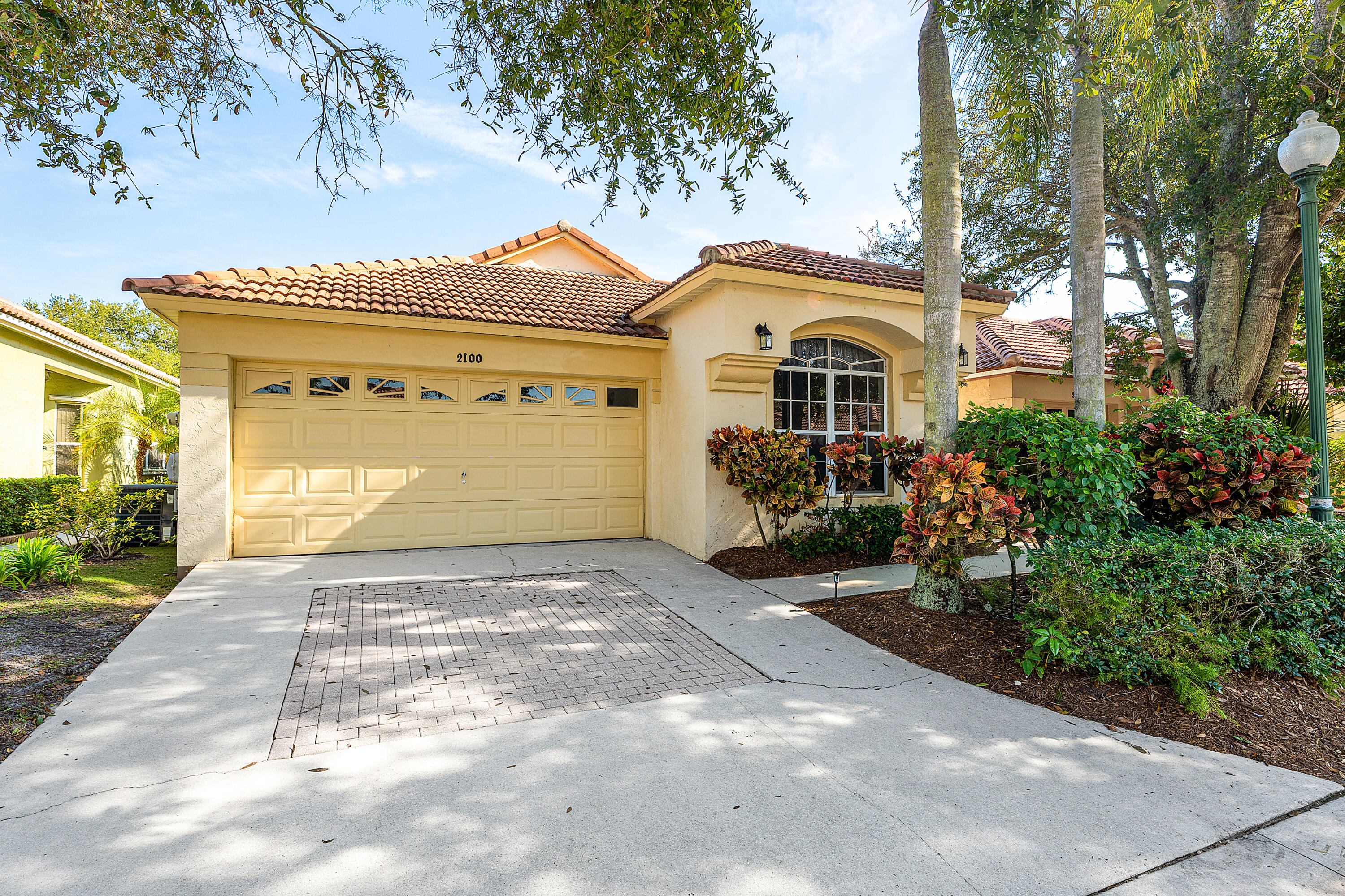 2100 Bonisle Circle Riviera Beach, FL 33418 - Photo 1 of 24 a front view of a house with a yard and garage
