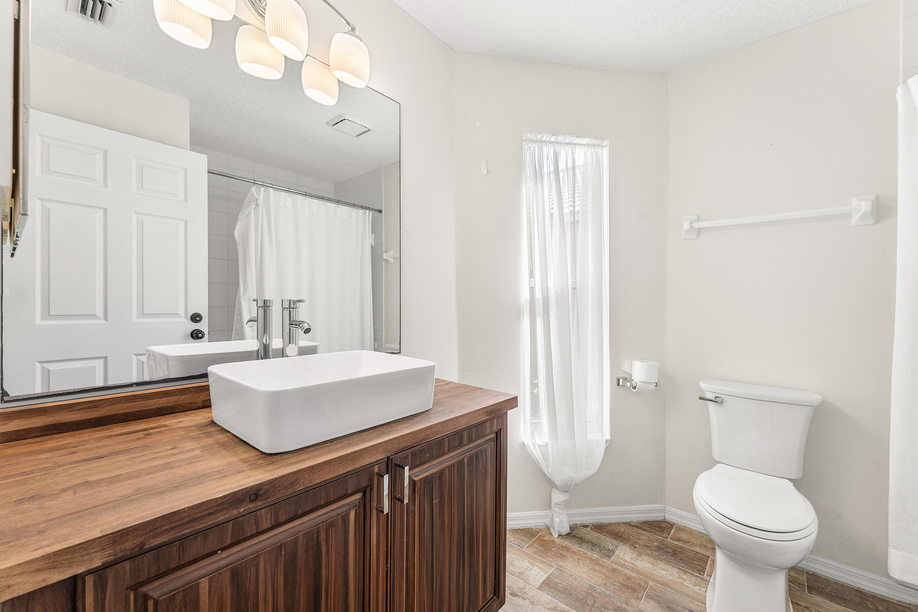 2100 Bonisle Circle Riviera Beach, FL 33418 - Photo 12 of 24 a bathroom with a sink toilet and shower