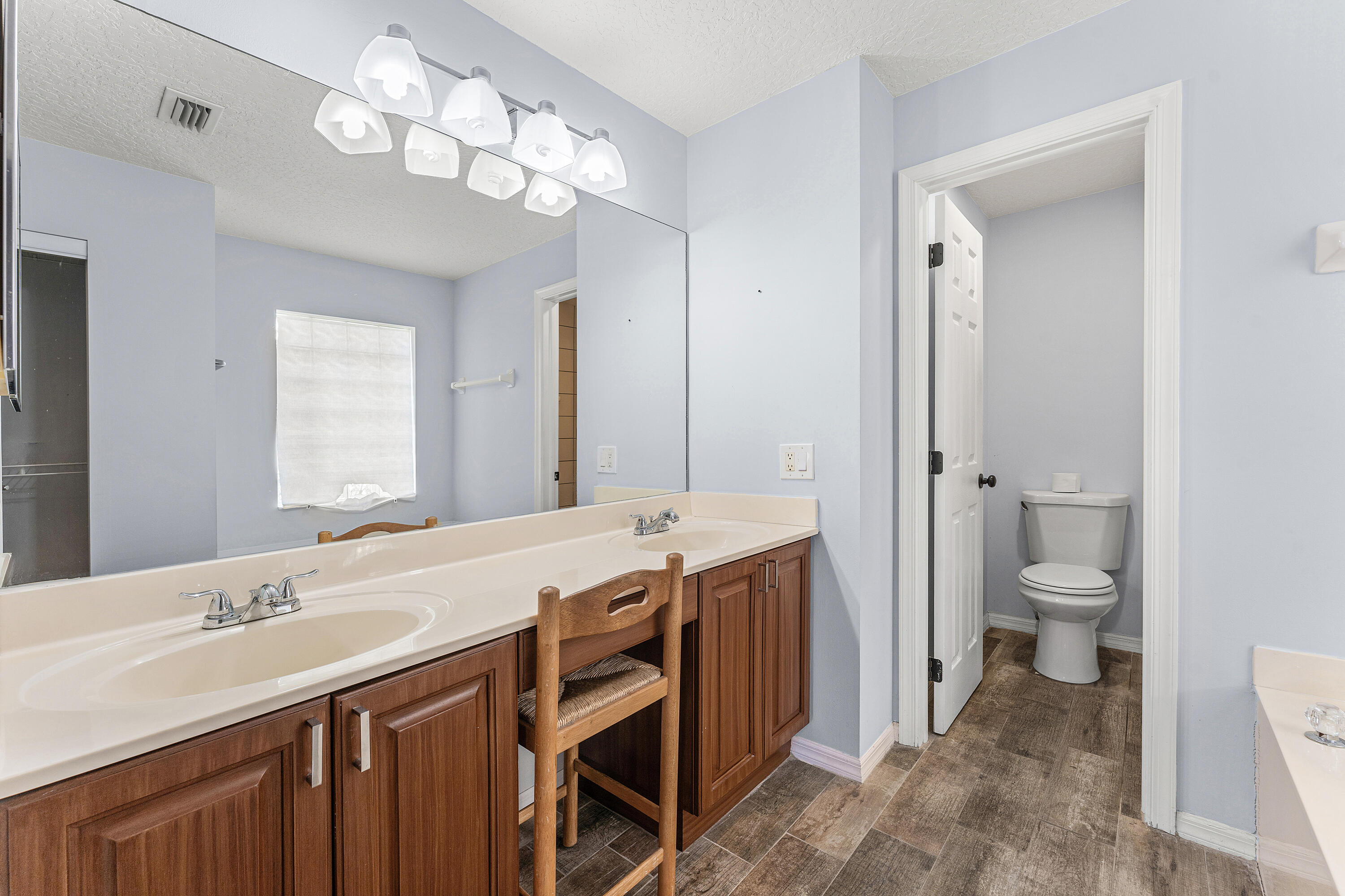2100 Bonisle Circle Riviera Beach, FL 33418 - Photo 15 of 24 a spacious bathroom with a granite countertop sink a toilet and a mirror