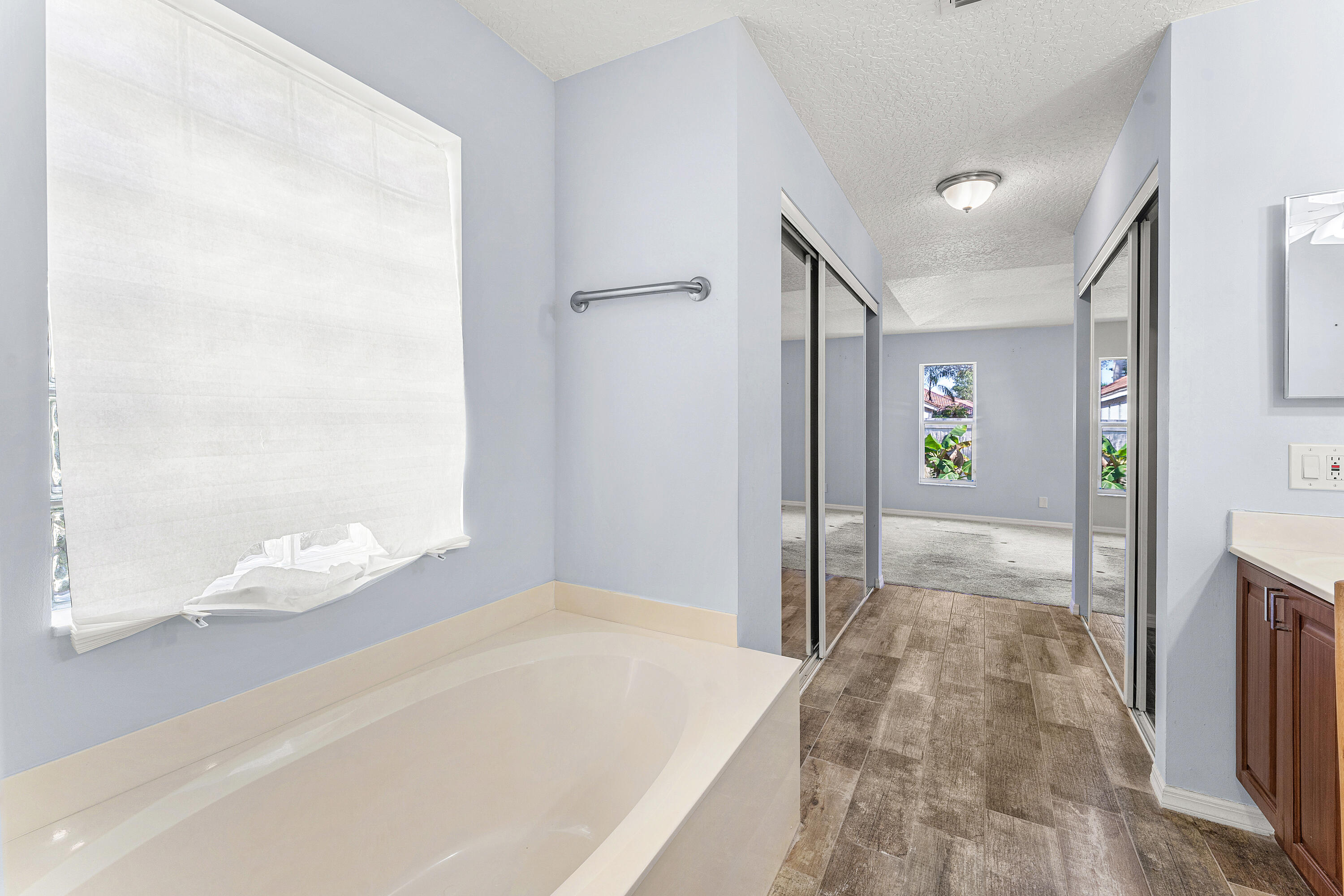 2100 Bonisle Circle Riviera Beach, FL 33418 - Photo 16 of 24 a bathroom with a bathtub and shower