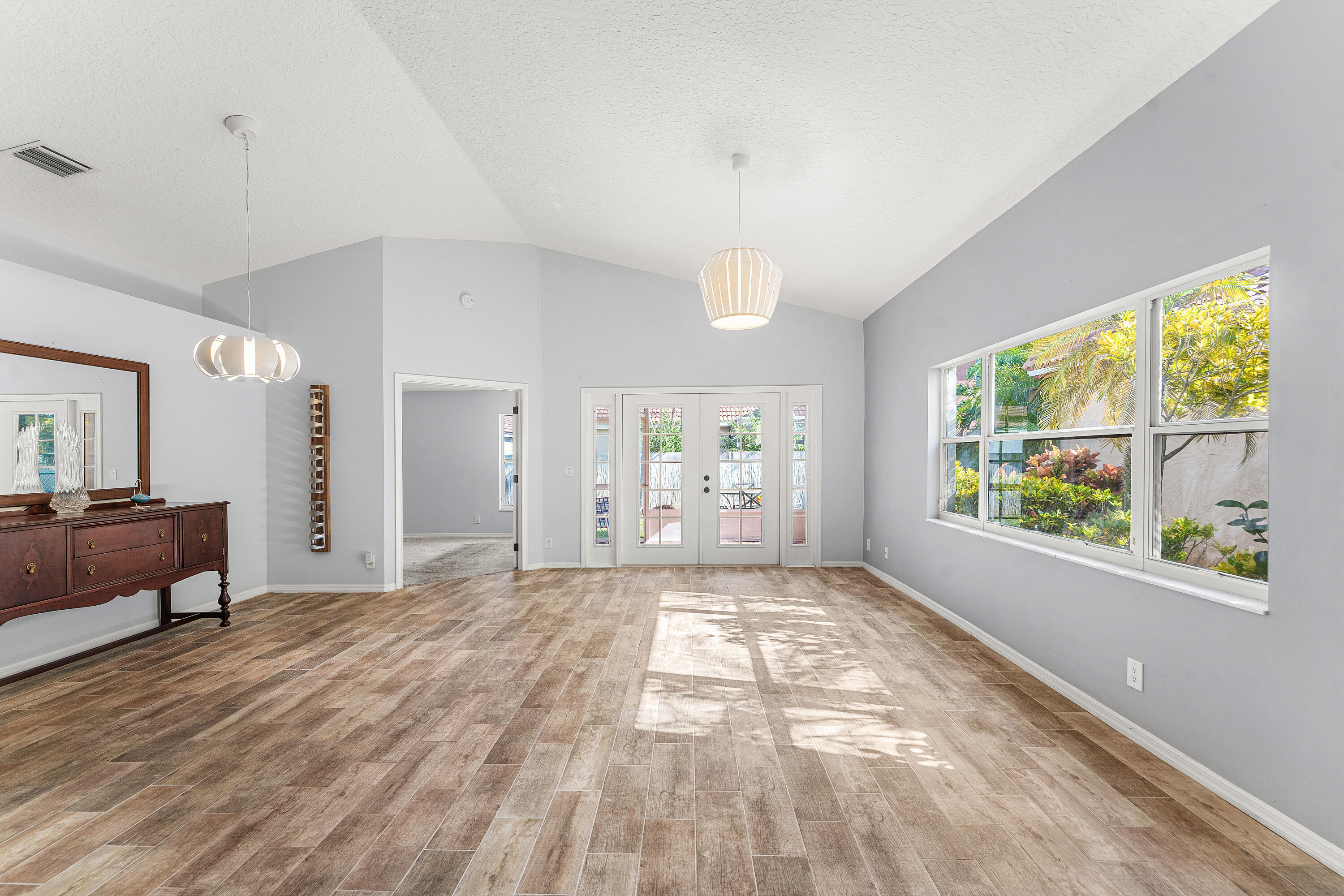 2100 Bonisle Circle Riviera Beach, FL 33418 - Photo 5 of 24 a view of a big room with wooden floor and windows