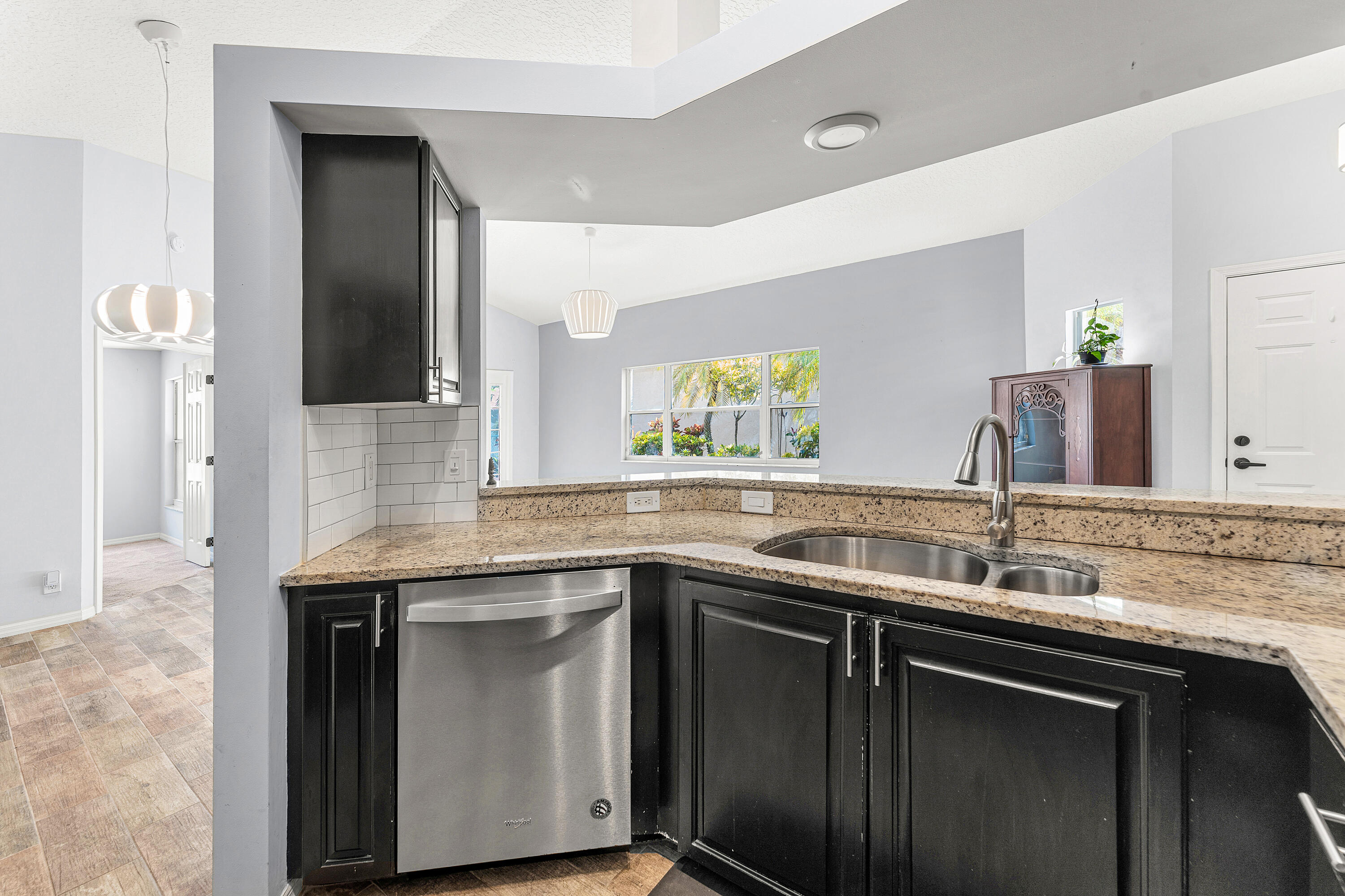 2100 Bonisle Circle Riviera Beach, FL 33418 - Photo 9 of 24 a kitchen with a sink and a refrigerator