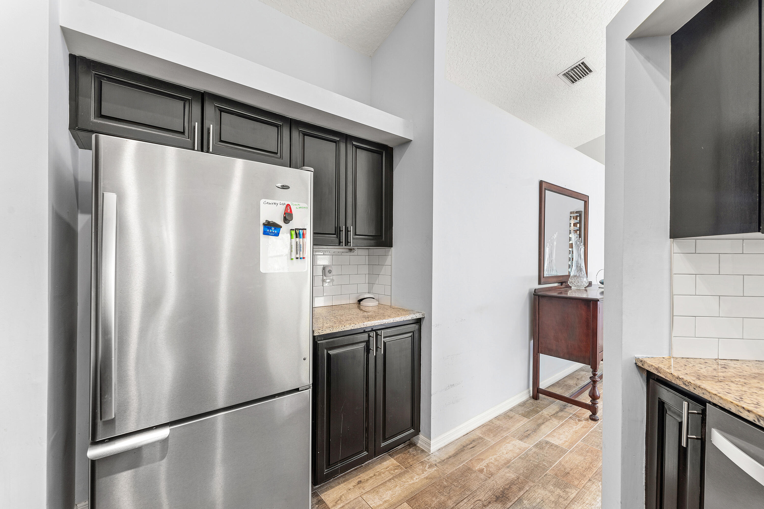 2100 Bonisle Circle Riviera Beach, FL 33418 - Photo 10 of 24 a white refrigerator freezer sitting inside of a kitchen