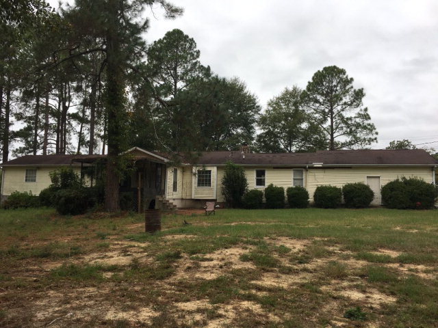 3334 Hamlin Road Lizella, GA 31052 - Photo 3 of 11 a view of a house with a yard and a large tree