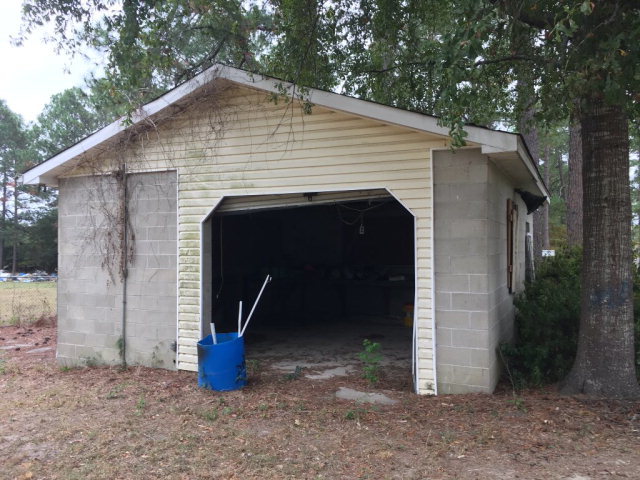 3334 Hamlin Road Lizella, GA 31052 - Photo 10 of 11 a view of a small house with large trees