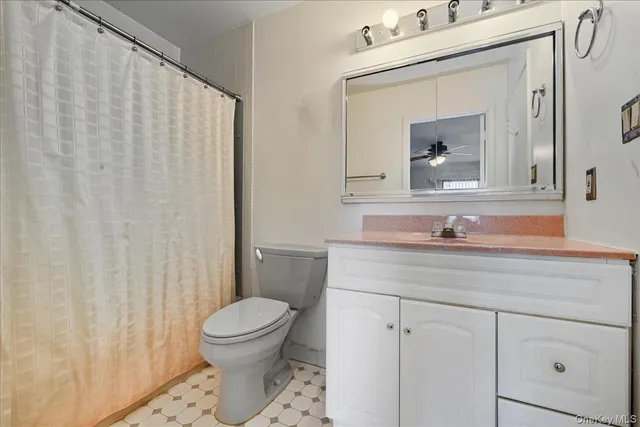 a bathroom with a toilet a sink and a mirror