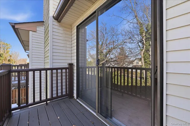 a view of a balcony with wooden floor