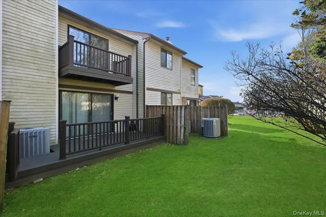 a view of a house with a yard and deck