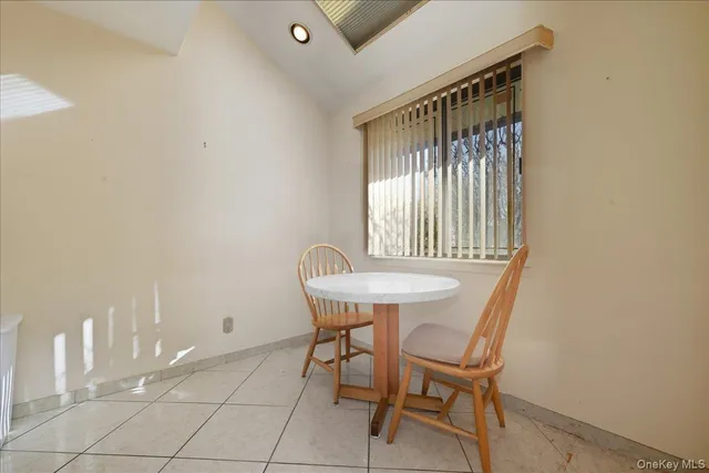 a view of a room with a table and chairs