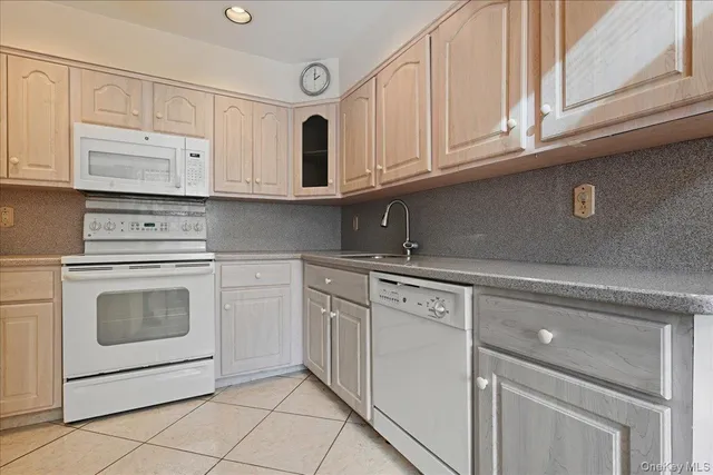 a kitchen with granite countertop white cabinets stainless steel appliances and sink