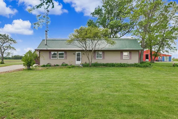 a front view of house with yard and green space