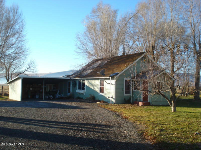a front view of house with a garden