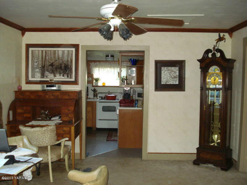 2670 Jensen Road Toppenish, WA 98948 - Photo 3 of 6 a kitchen with stainless steel appliances kitchen island granite countertop furniture and a fireplace
