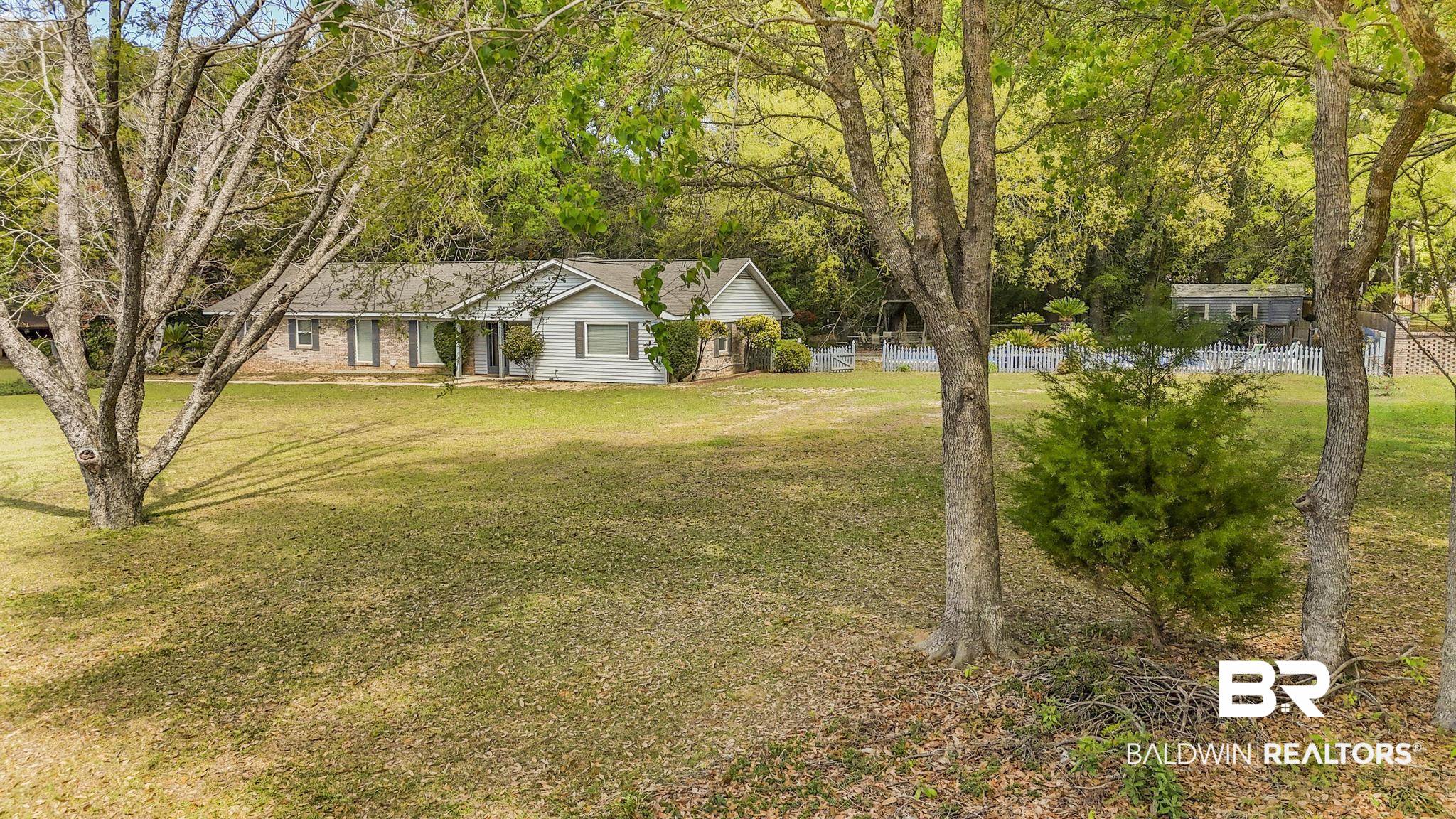 10207 Plantation Drive Daphne, AL 36526 - Photo 5 of 48 View of front of house featuring a front lawn and view of wooded area