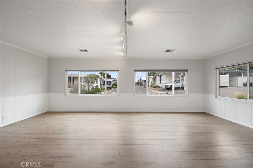 1675 Los Osos Valley Road, Unit 135 Los Osos, CA 93402 - Photo 11 of 38 a view of an empty room with window and wooden floor
