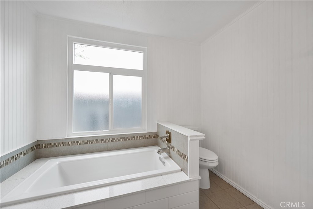 1675 Los Osos Valley Road, Unit 135 Los Osos, CA 93402 - Photo 23 of 38 a bathroom with a tub and a window