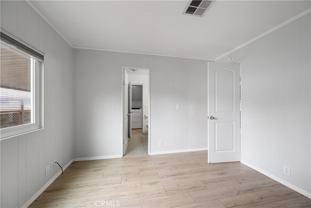 1675 Los Osos Valley Road, Unit 135 Los Osos, CA 93402 - Photo 26 of 38 a view of an empty room with window and wooden floor