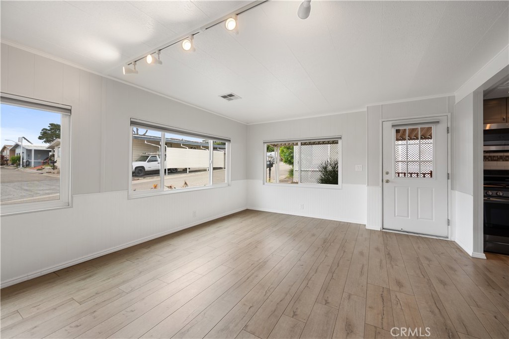 1675 Los Osos Valley Road, Unit 135 Los Osos, CA 93402 - Photo 10 of 38 an empty room with wooden floor and windows