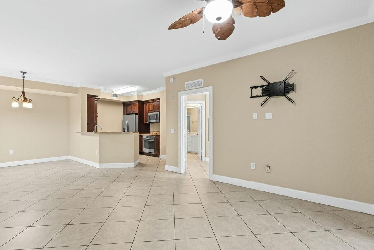 1690 Renaissance Commons Boulevard, Unit 1125 Boynton Beach, FL 33426 - Photo 11 of 37 an empty room with shelves and mirrors