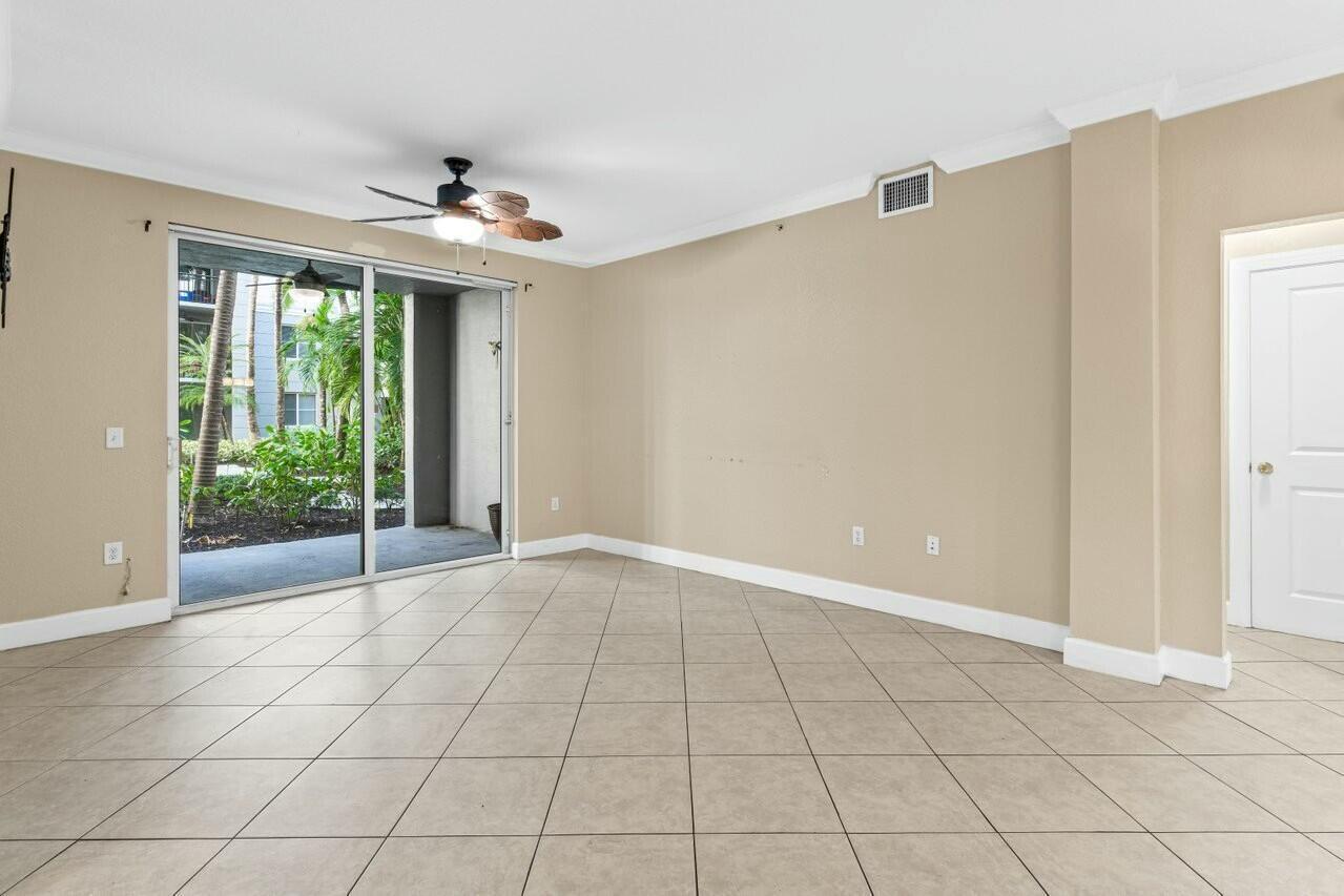 1690 Renaissance Commons Boulevard, Unit 1125 Boynton Beach, FL 33426 - Photo 12 of 37 a view of an empty room with a window