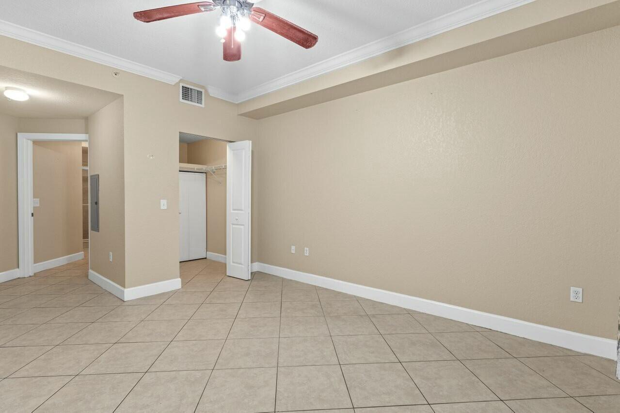1690 Renaissance Commons Boulevard, Unit 1125 Boynton Beach, FL 33426 - Photo 14 of 37 an empty room with fan and entryway