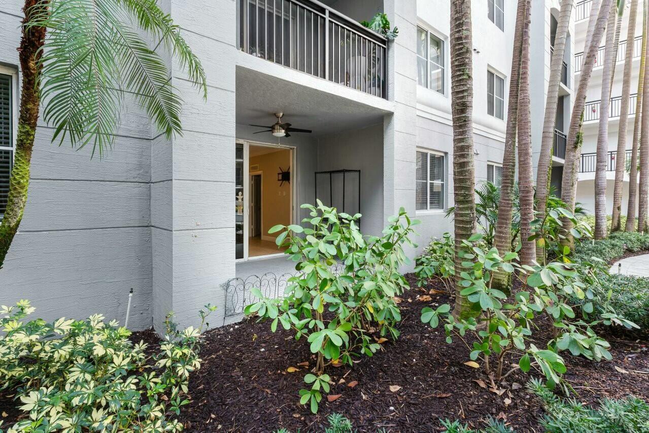 1690 Renaissance Commons Boulevard, Unit 1125 Boynton Beach, FL 33426 - Photo 22 of 37 a view of a pathway of a house