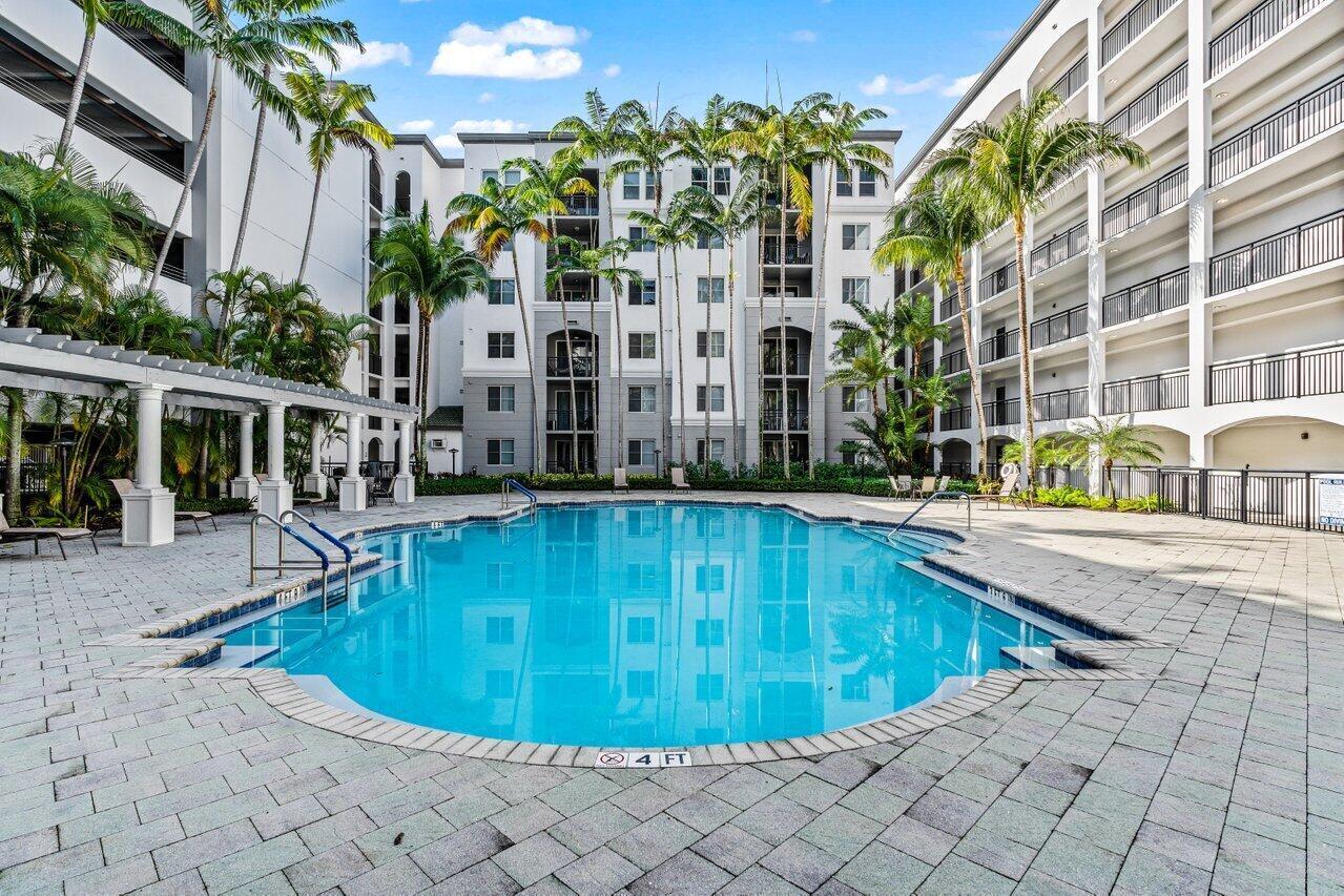 1690 Renaissance Commons Boulevard, Unit 1125 Boynton Beach, FL 33426 - Photo 28 of 37 a view of a swimming pool with a patio