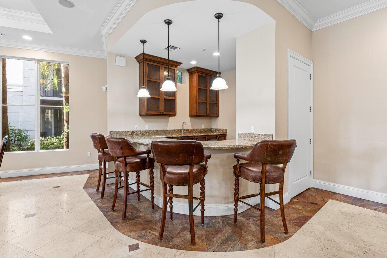 1690 Renaissance Commons Boulevard, Unit 1125 Boynton Beach, FL 33426 - Photo 34 of 37 a view of a dining room with furniture and a large window