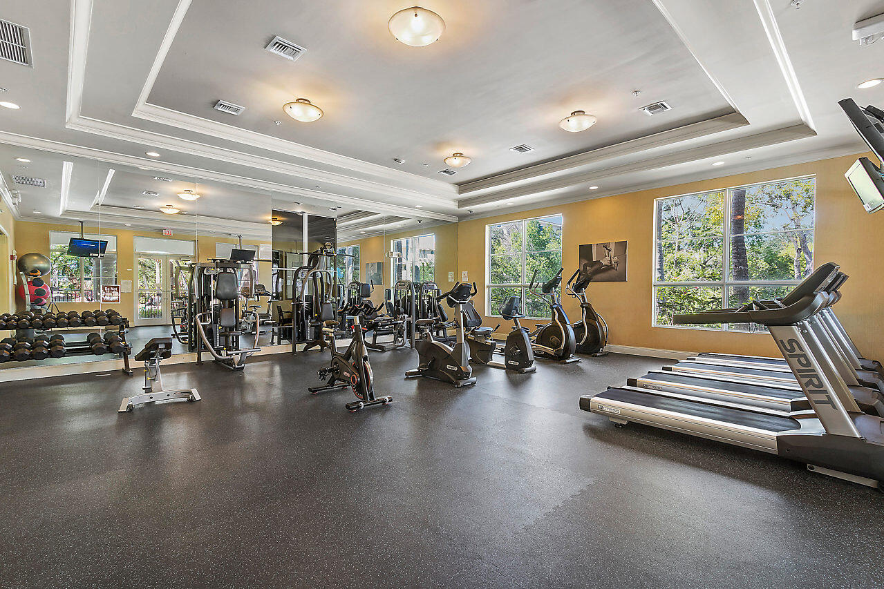 1690 Renaissance Commons Boulevard, Unit 1125 Boynton Beach, FL 33426 - Photo 36 of 37 a room with lots of gym equipment and a large window