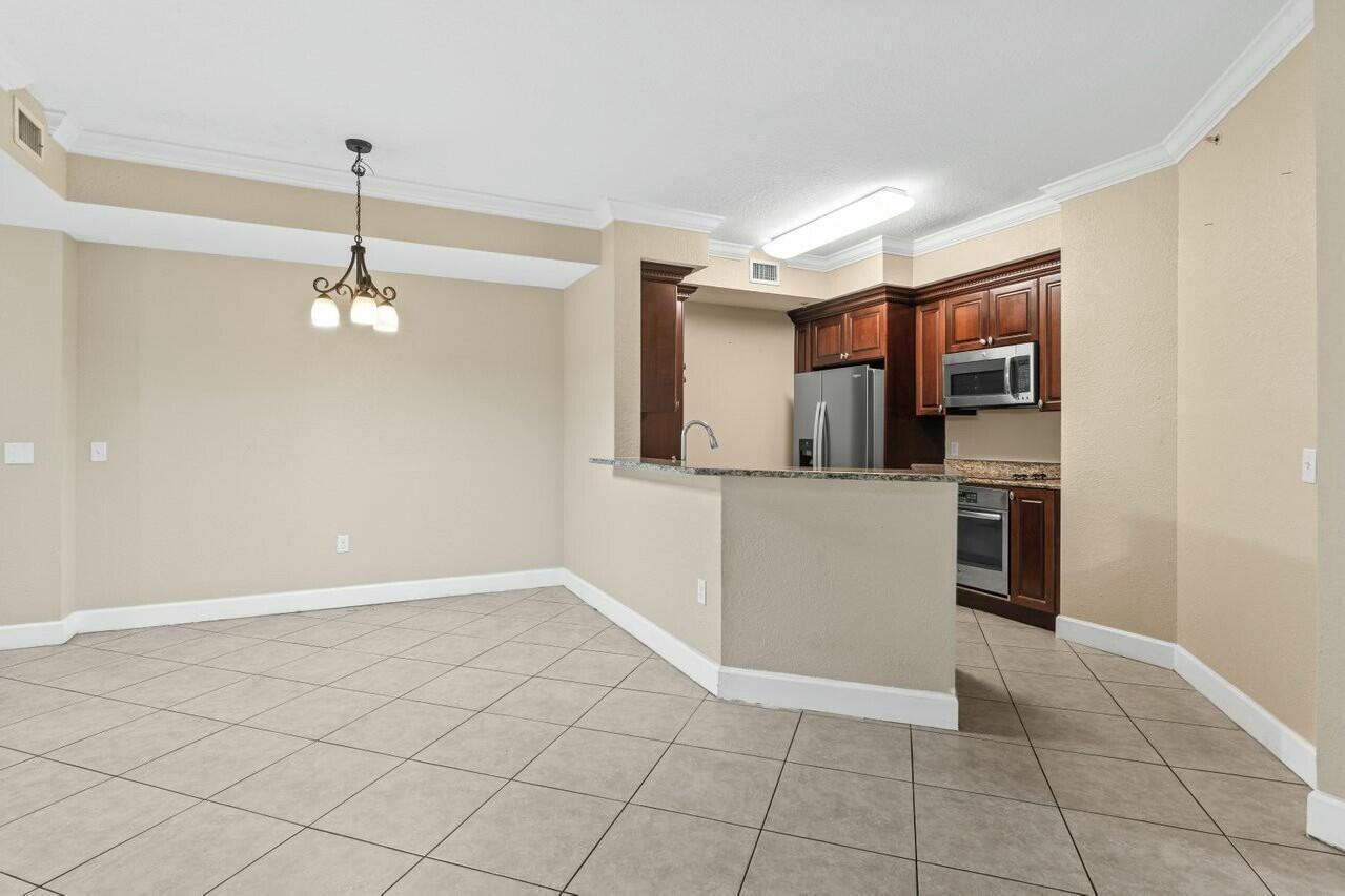 1690 Renaissance Commons Boulevard, Unit 1125 Boynton Beach, FL 33426 - Photo 7 of 37 a view of a kitchen with a sink
