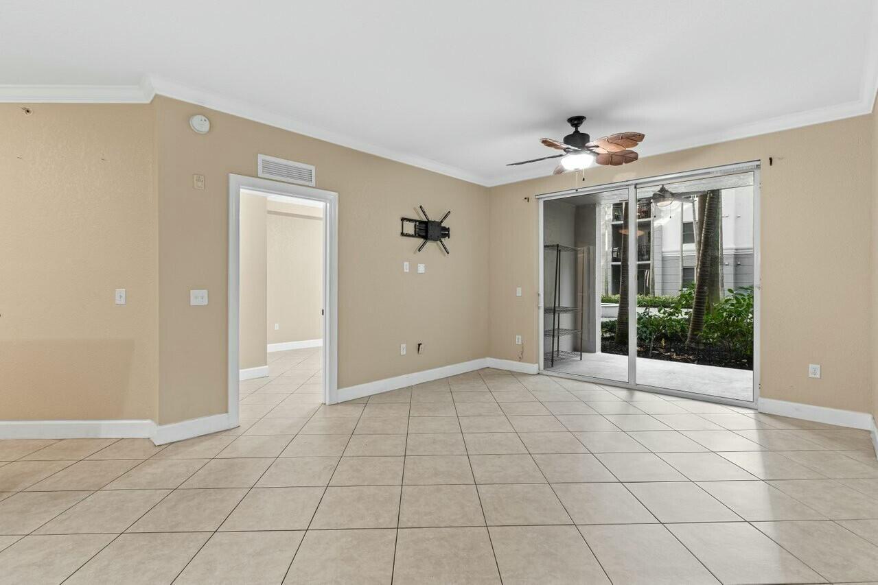 1690 Renaissance Commons Boulevard, Unit 1125 Boynton Beach, FL 33426 - Photo 10 of 37 a view of an empty room with a chandelier fan