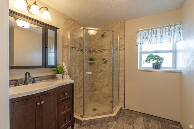 1045 Fox Farm Road Logan, UT 84321 - Photo 32 of 65 Bathroom featuring vanity, a shower stall, and a textured ceiling