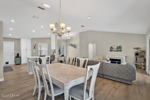 a view of a dining room with furniture and wooden floor