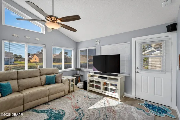 a living room with furniture and a flat screen tv