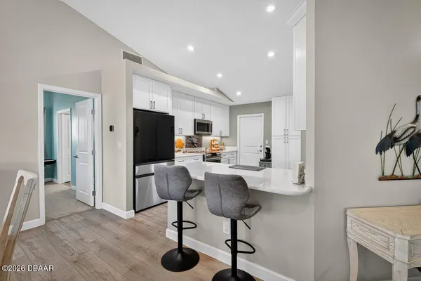a view of a livingroom with furniture and a flat screen tv