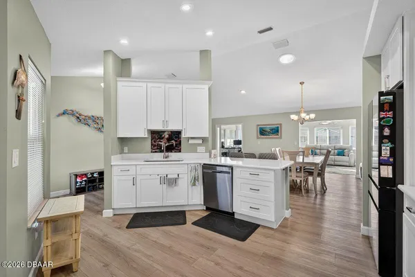 a kitchen with white cabinets and white appliances