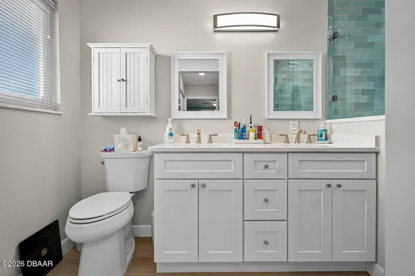 a bathroom with a toilet sink and mirror