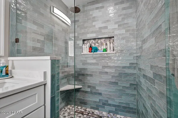 a bathroom with a shower and a sink