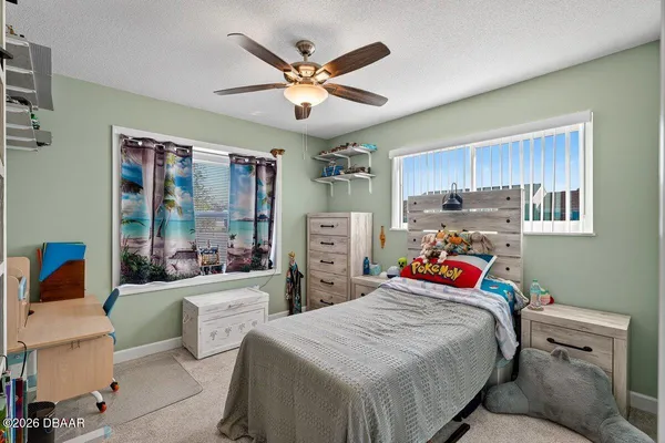 a bedroom with a bed and a large window