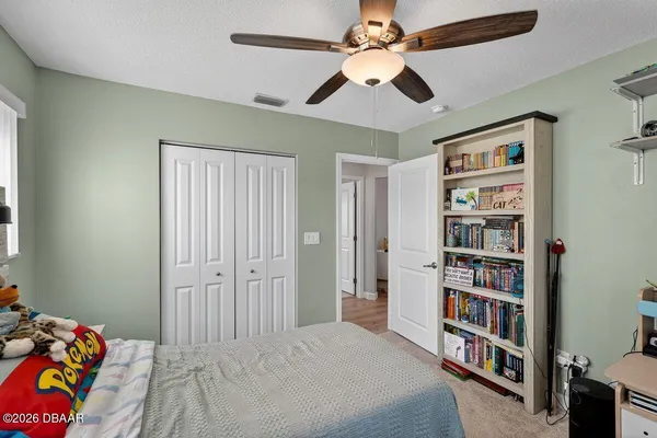 a bedroom with a bed cabinets and a book shelf