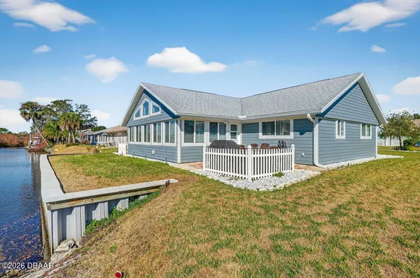 a view of a house with pool and deck